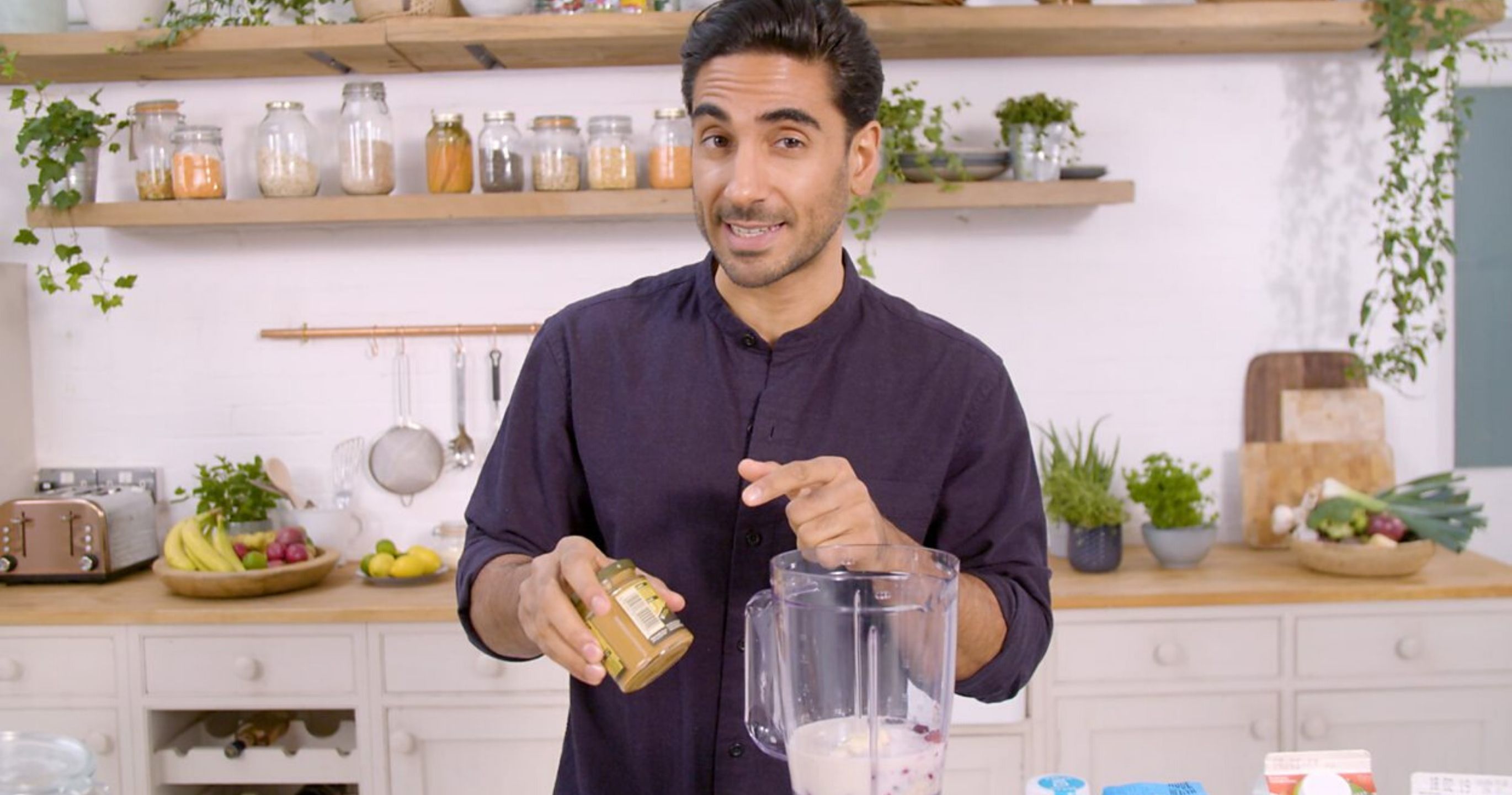 Dr Rupy Aujla cooking in his kitchen, with his blender on the worktop