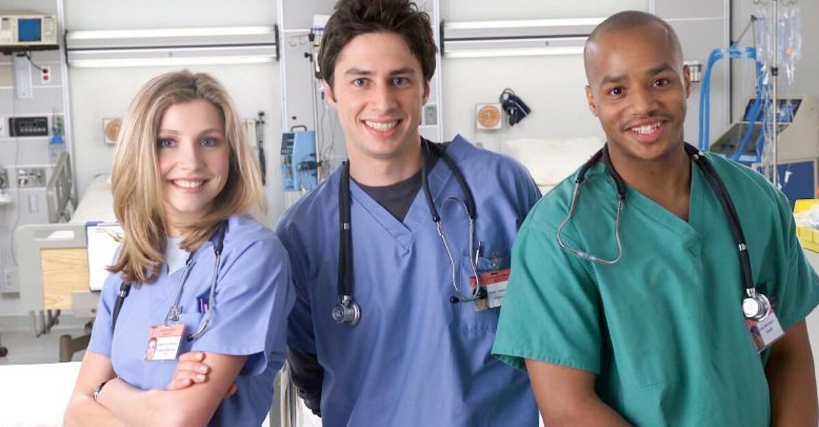 Cast of Scrubs in a hospital smiling at the camera