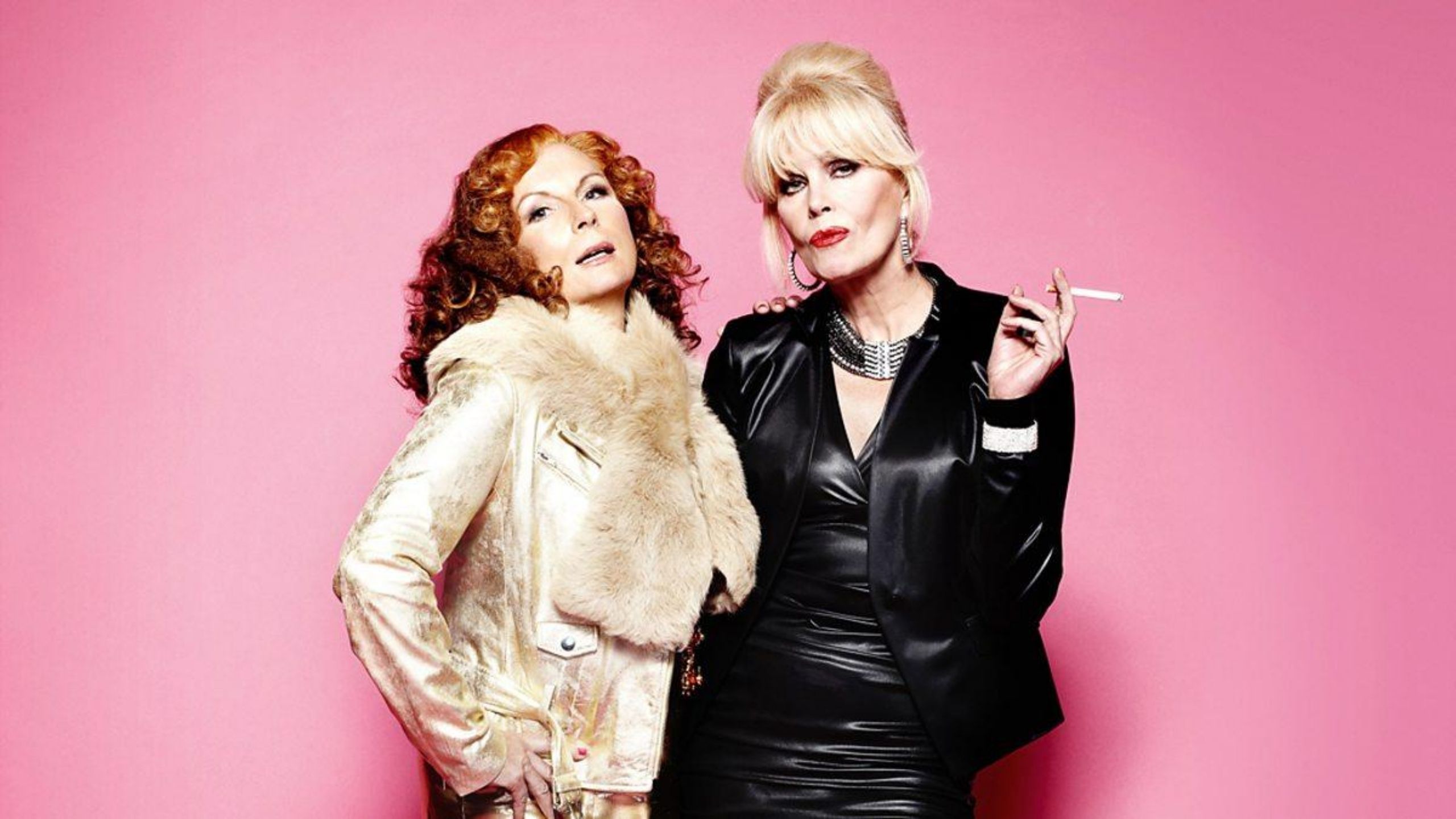 Jennifer Saunders and Joanna Lumley looking glamorous against a pink background