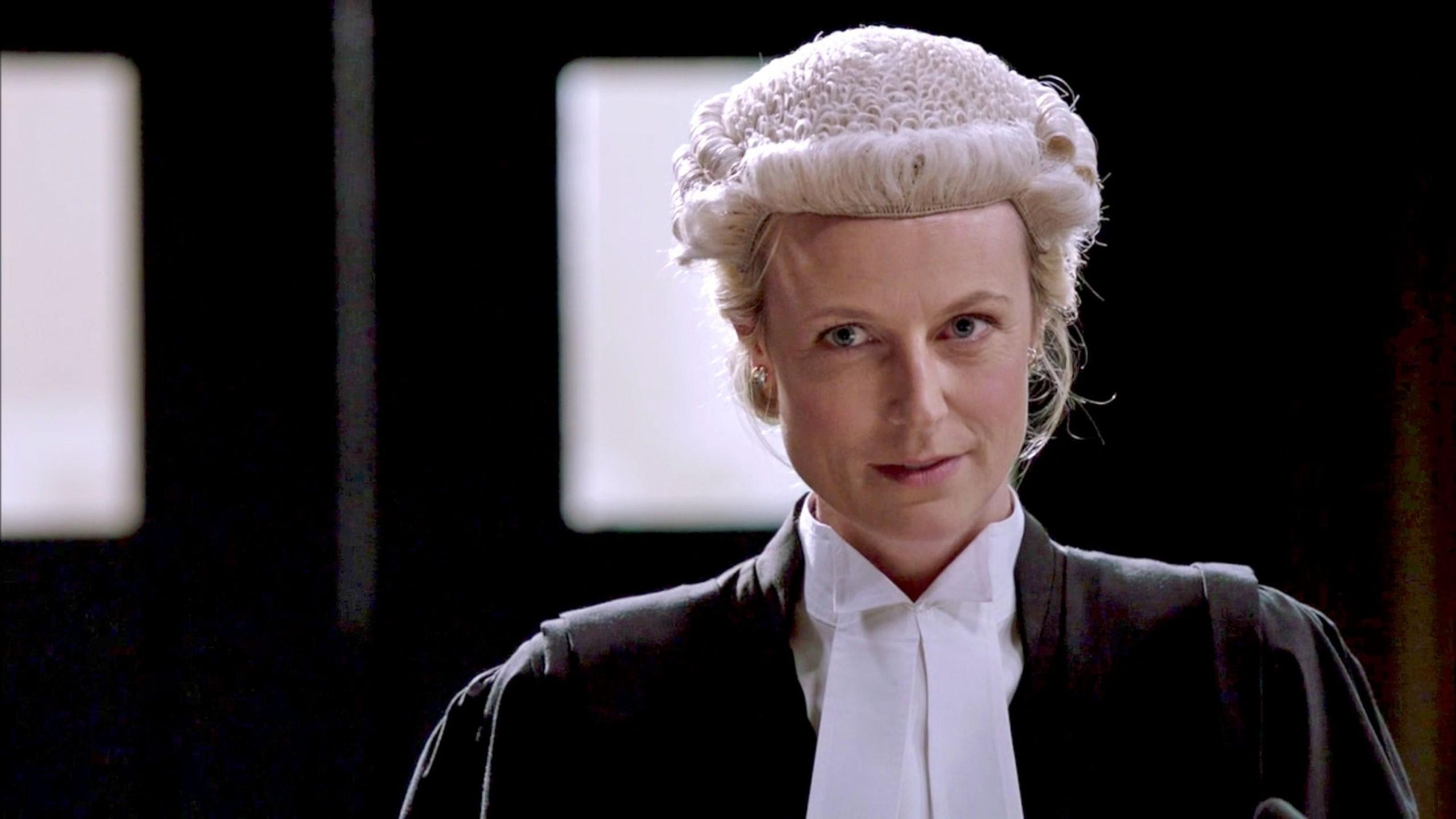 Female prosecutor in the courtroom wearing wig and gown