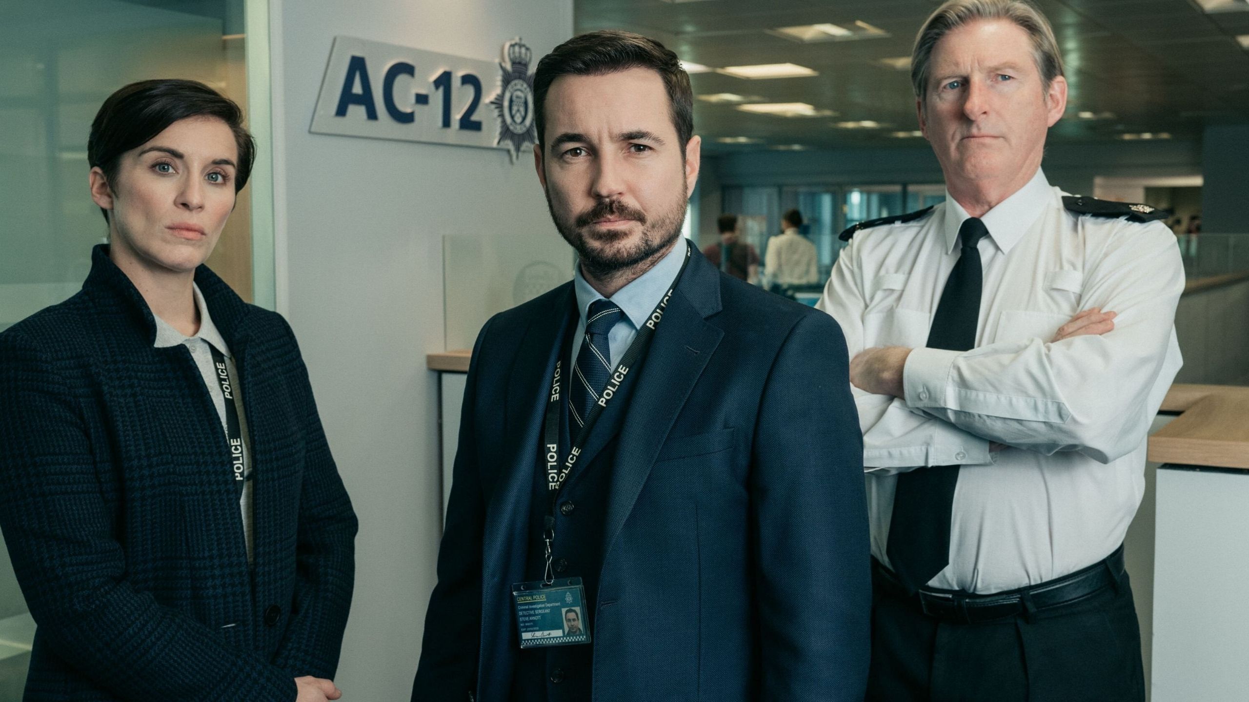 Cast of Line of Duty stood in a police department looking