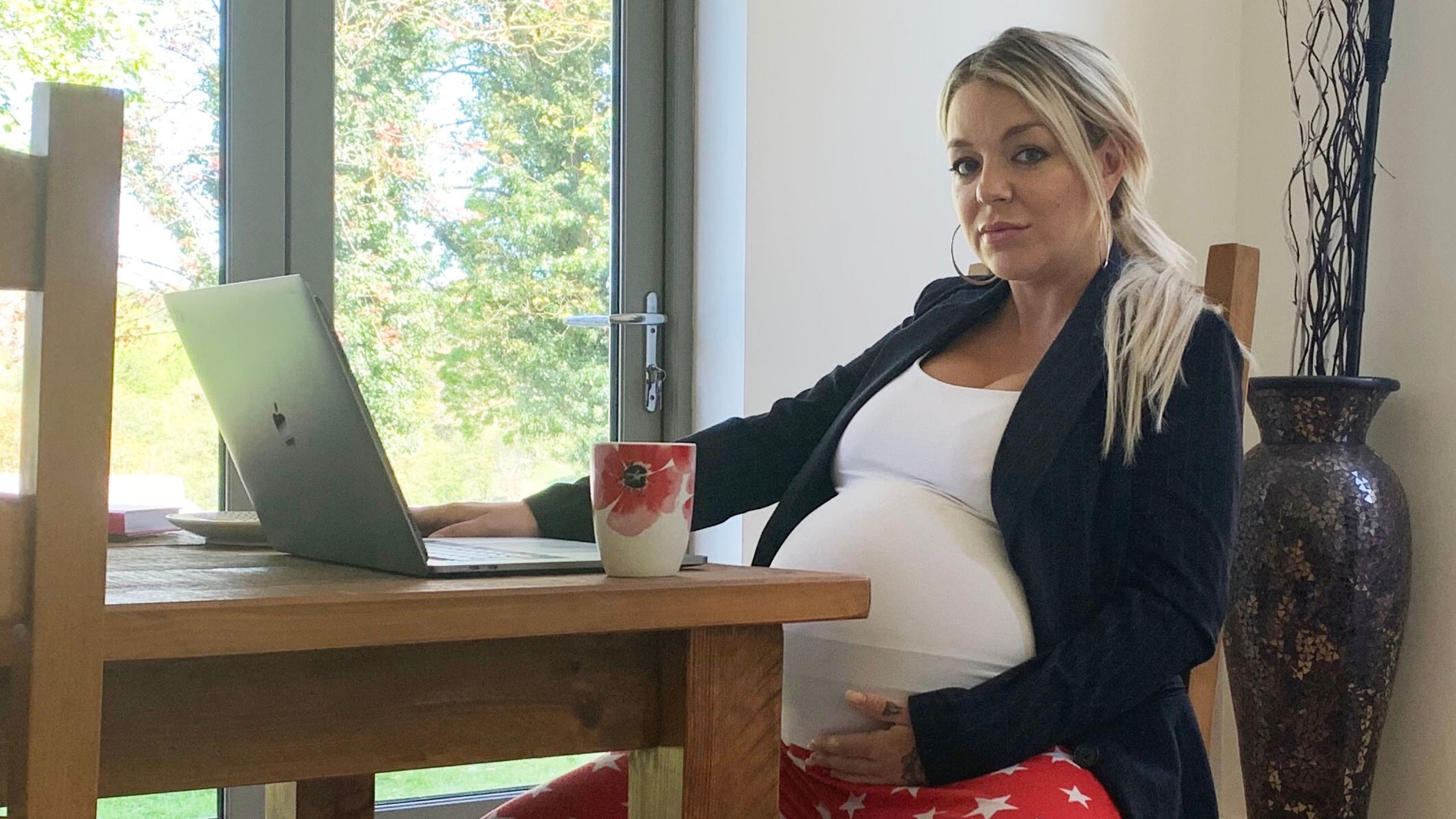 Sherdian Smith sits at her kitchen table in front of her laptop