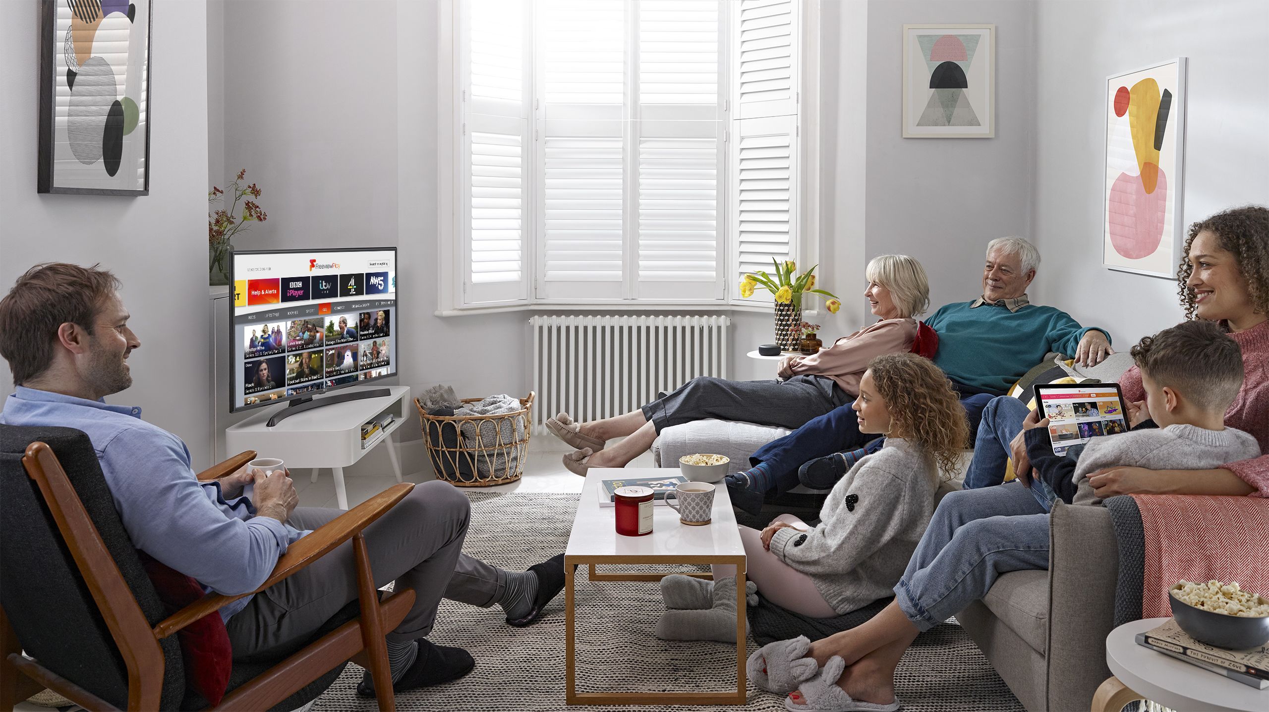 A family group watching Freeview Play in their living room