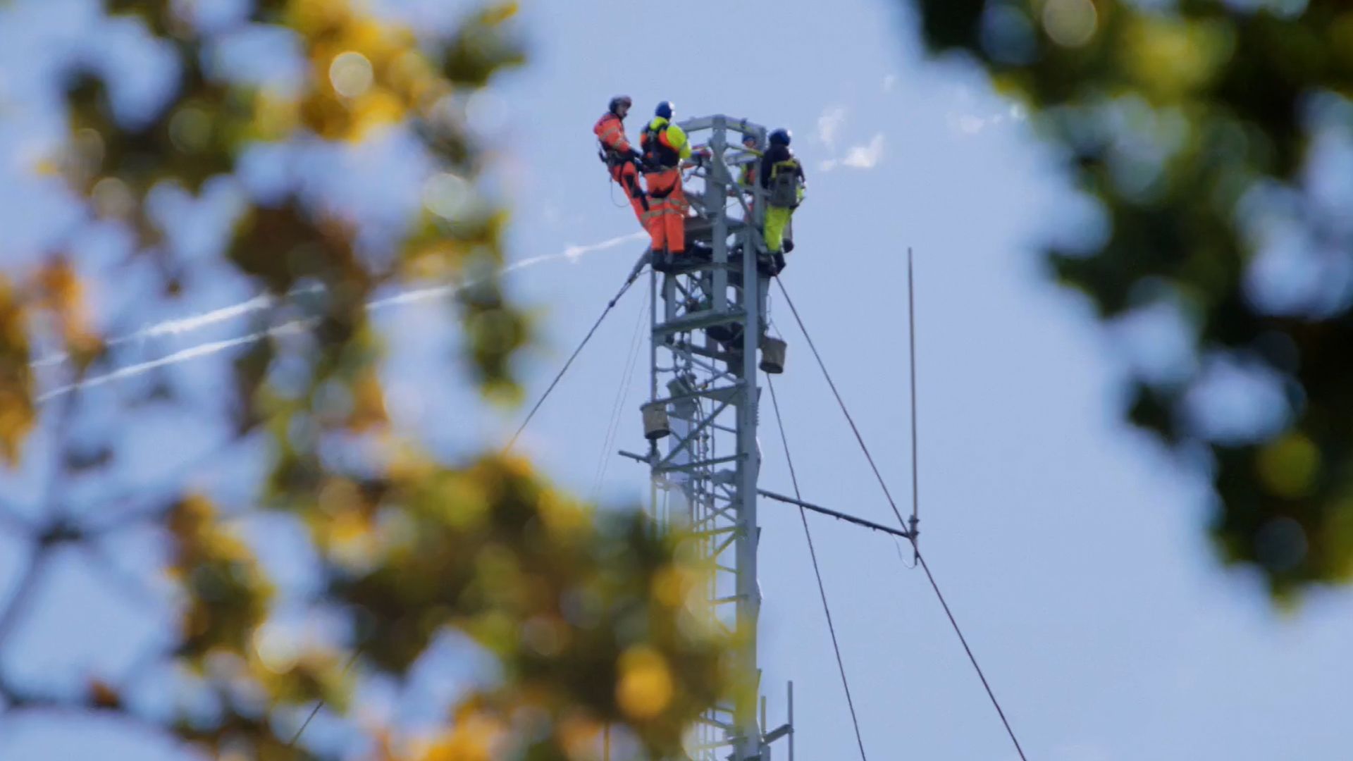 Three engineers working on a TV transmitter