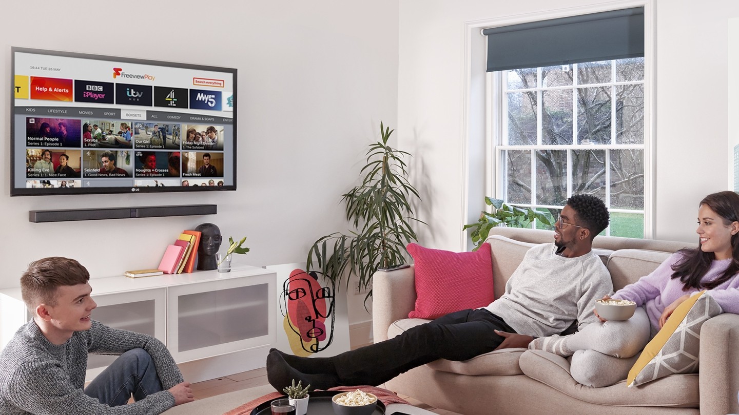 Three young viewers watching Freeview Play on an LG TV