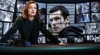 Image of Detective Carey from BBC's The Capture, standing behind CCTV screens