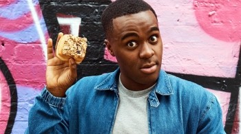 Liam Charles holds up a pastry to the camera