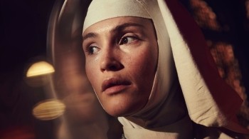 Close up image of Gemma Arterton as a nun in Black Narcissus, background is blurred