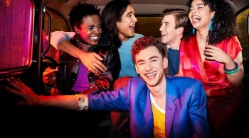 Group of friends laughing in the back of a taxi