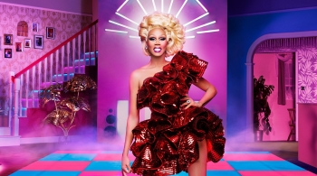 Ru Paul in a glamourous red dress in the Drag Race studio