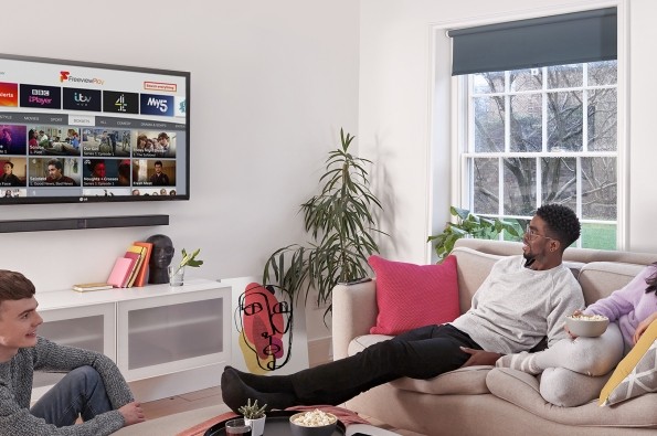 Three young viewers watching Freeview Play on an LG TV