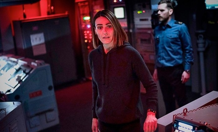 Suranne Jones stands in a darkened generator room