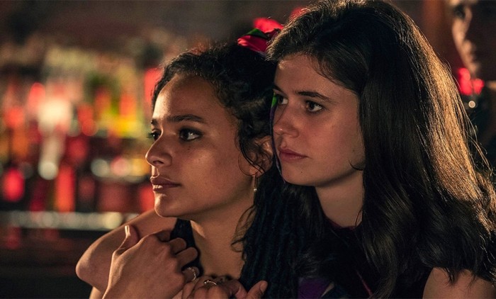 Picture of two girlfriends against a background of bright lights