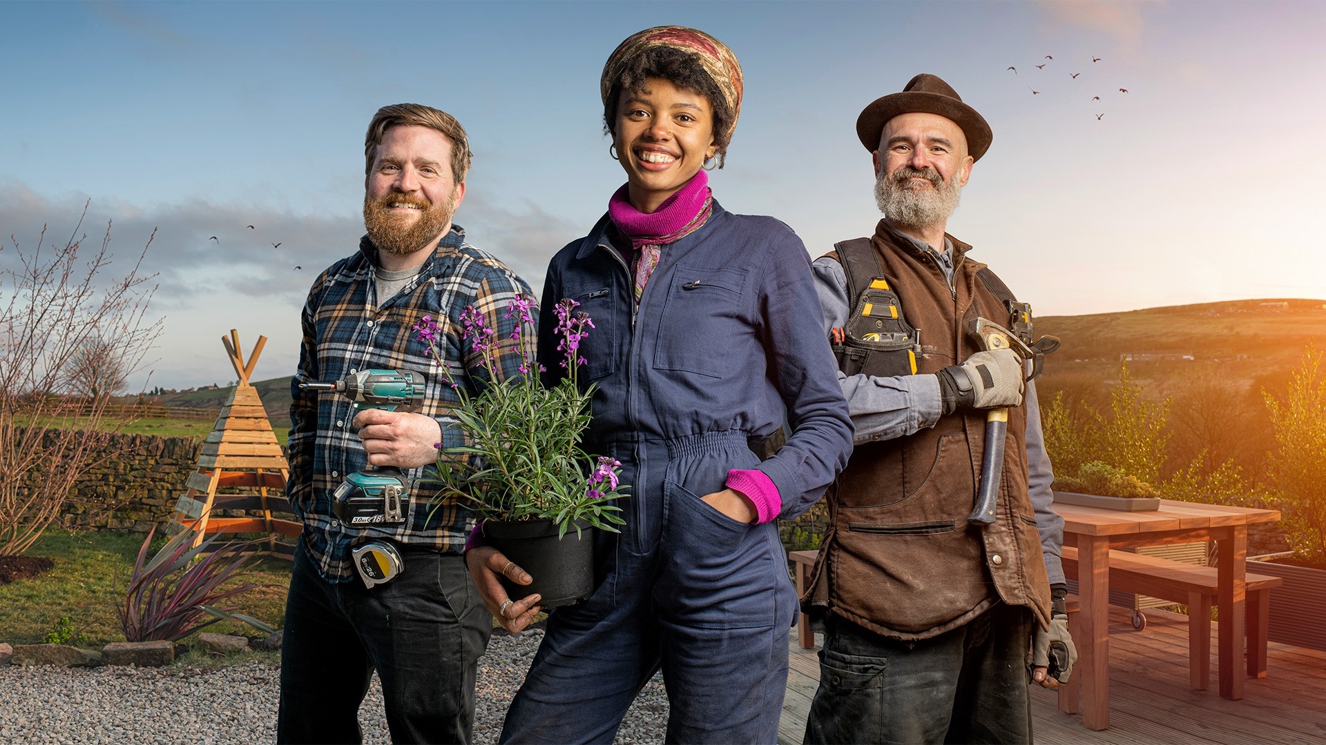 The three expert gardeners stood in a beautiful green garden