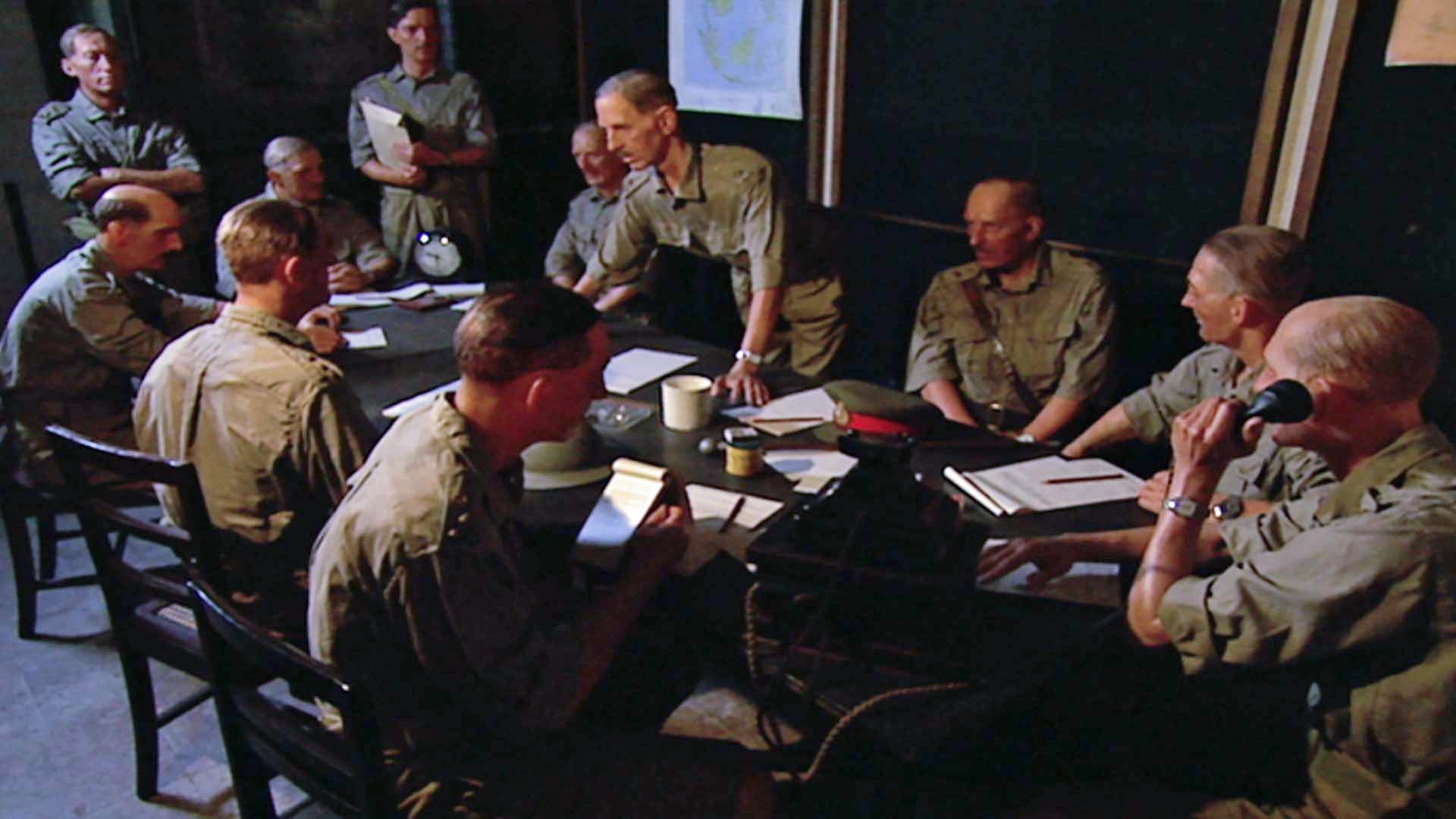A group of military men gathered around a table