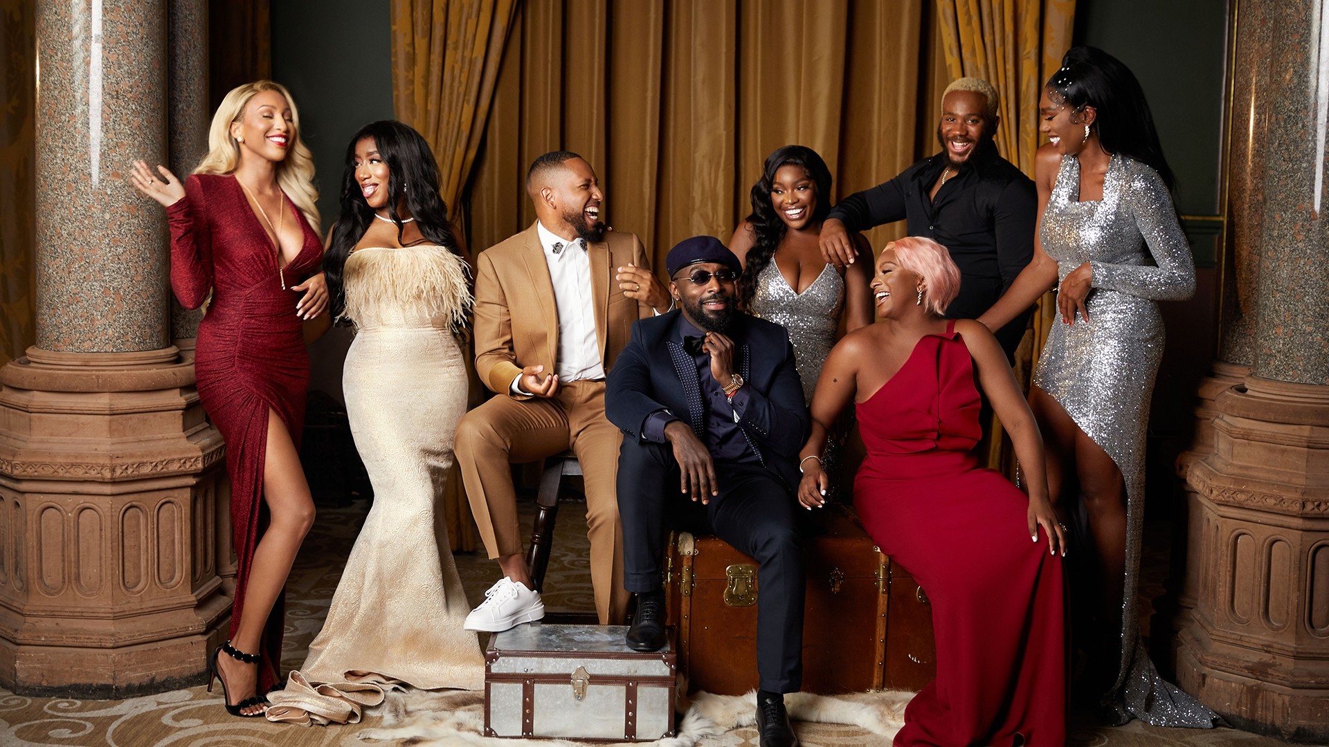 Group of young Black British people glamorously dressed and laughing together