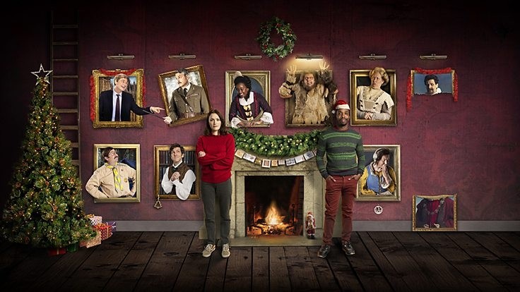 Alison and Mike stand in their stately home surrounded by the portraits of the ghosts