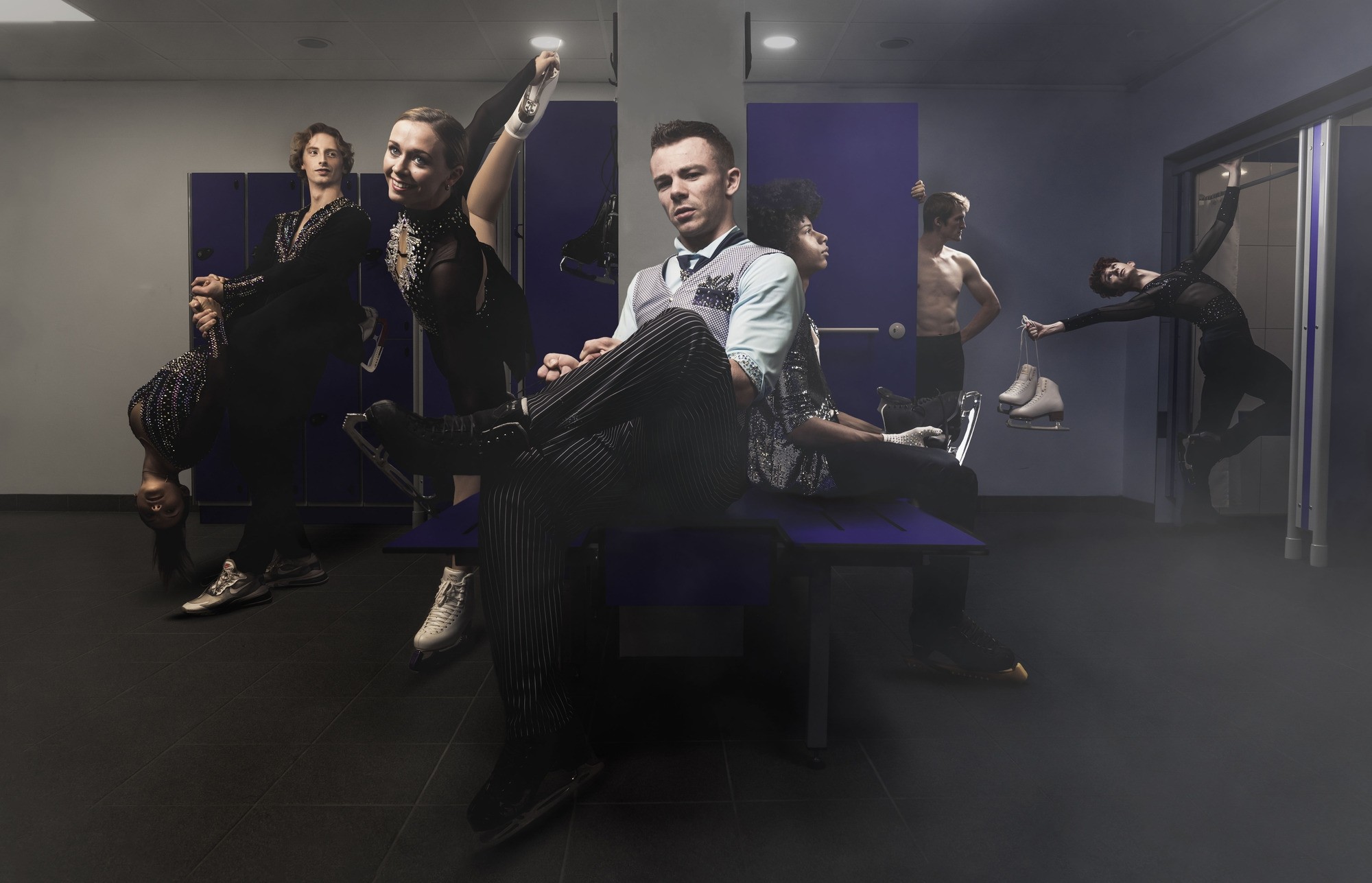 A group of young figure skaters in a dressing room