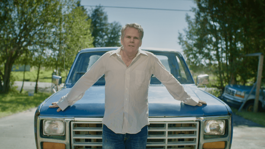 man stood in front of a vintage style car