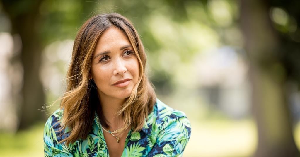Myleene Klass looks introspective, sat in a park