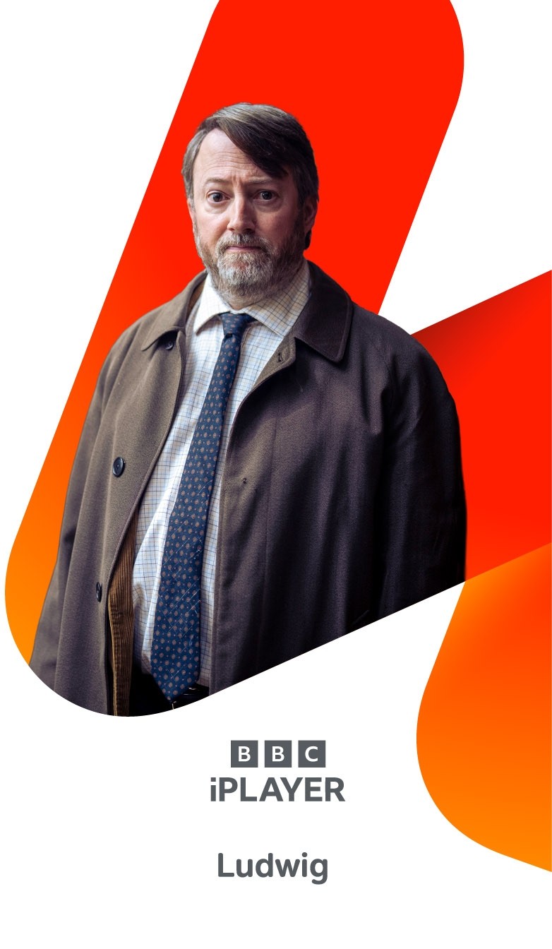 Person wearing a brown overcoat, shirt and patterned tie, standing in front of an orange graphic shape above BBC iPlayer and Ludwig branding.